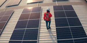 Maintenance worker on roof of agricultural building